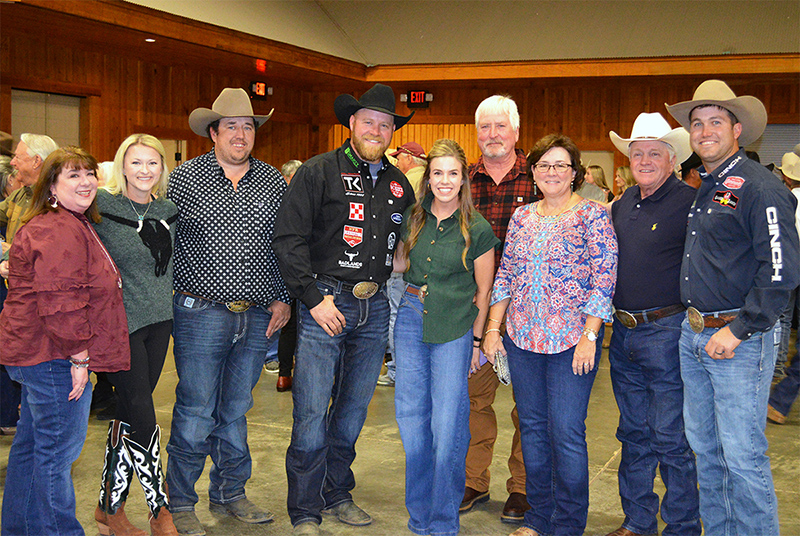 Among the 2024 Town Creek Farm Bull Sale buyers were J.D. Robinson and family on the left, five-time World Champion Professional Steer wrestler Tyler Waguespack on the right, and David Orman on the back. Professional Steer Wrestler Will Lummus and his family are pictured with the bull buyers.
